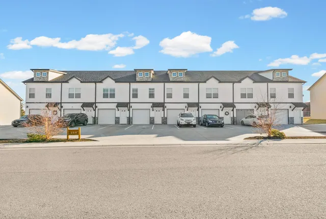 a view of building with outdoor space and parking