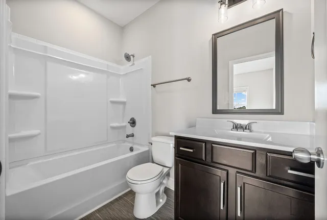 a bathroom with a sink a toilet and bathtub