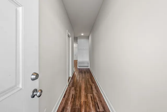 a view of a hallway with wooden floor