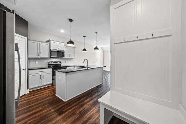 a kitchen with white cabinets and white appliances