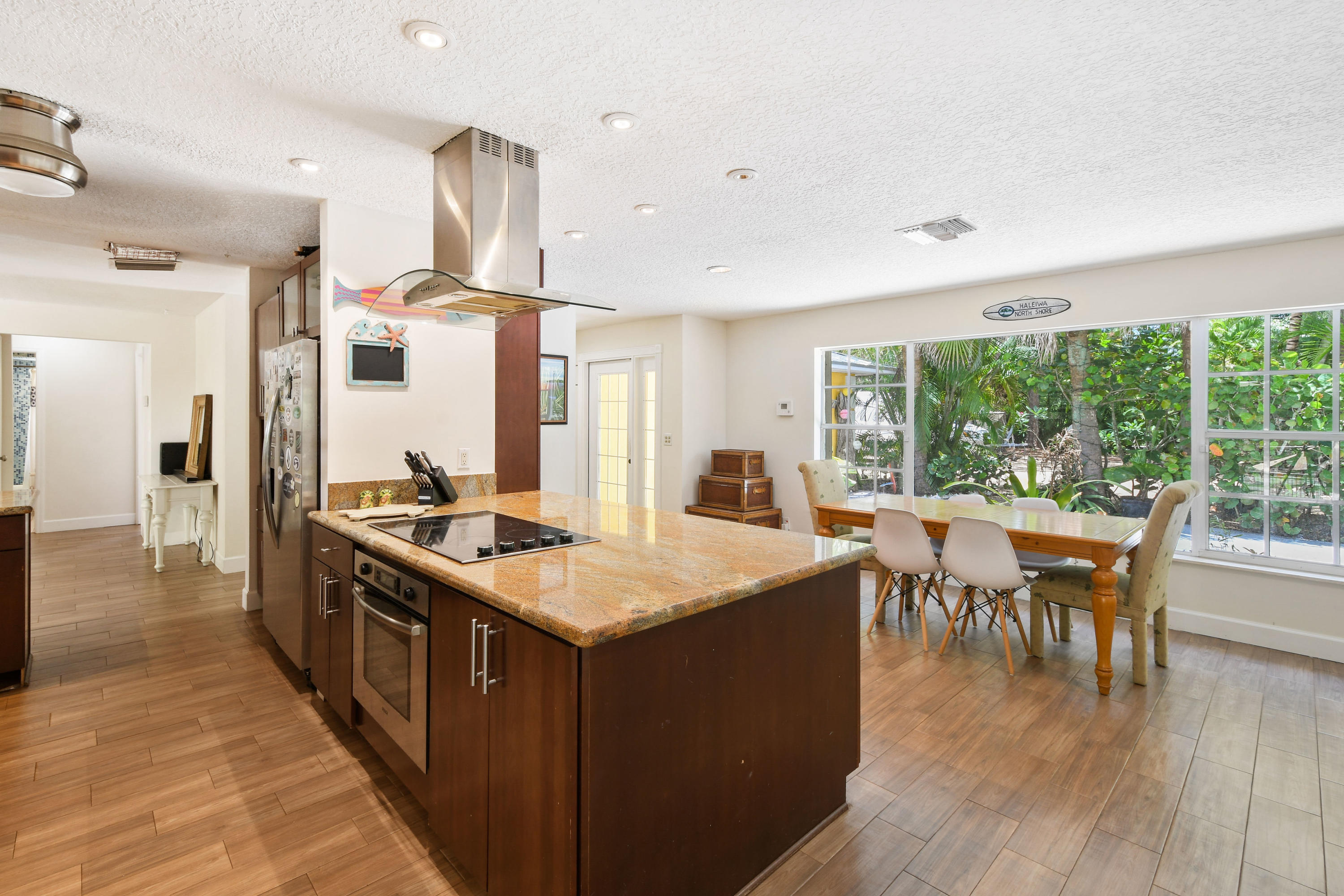 19943 Pinetree Drive Jupiter, FL 33469 - Photo 11 of 42 a open kitchen with stainless steel appliances granite countertop a stove and wooden floor
