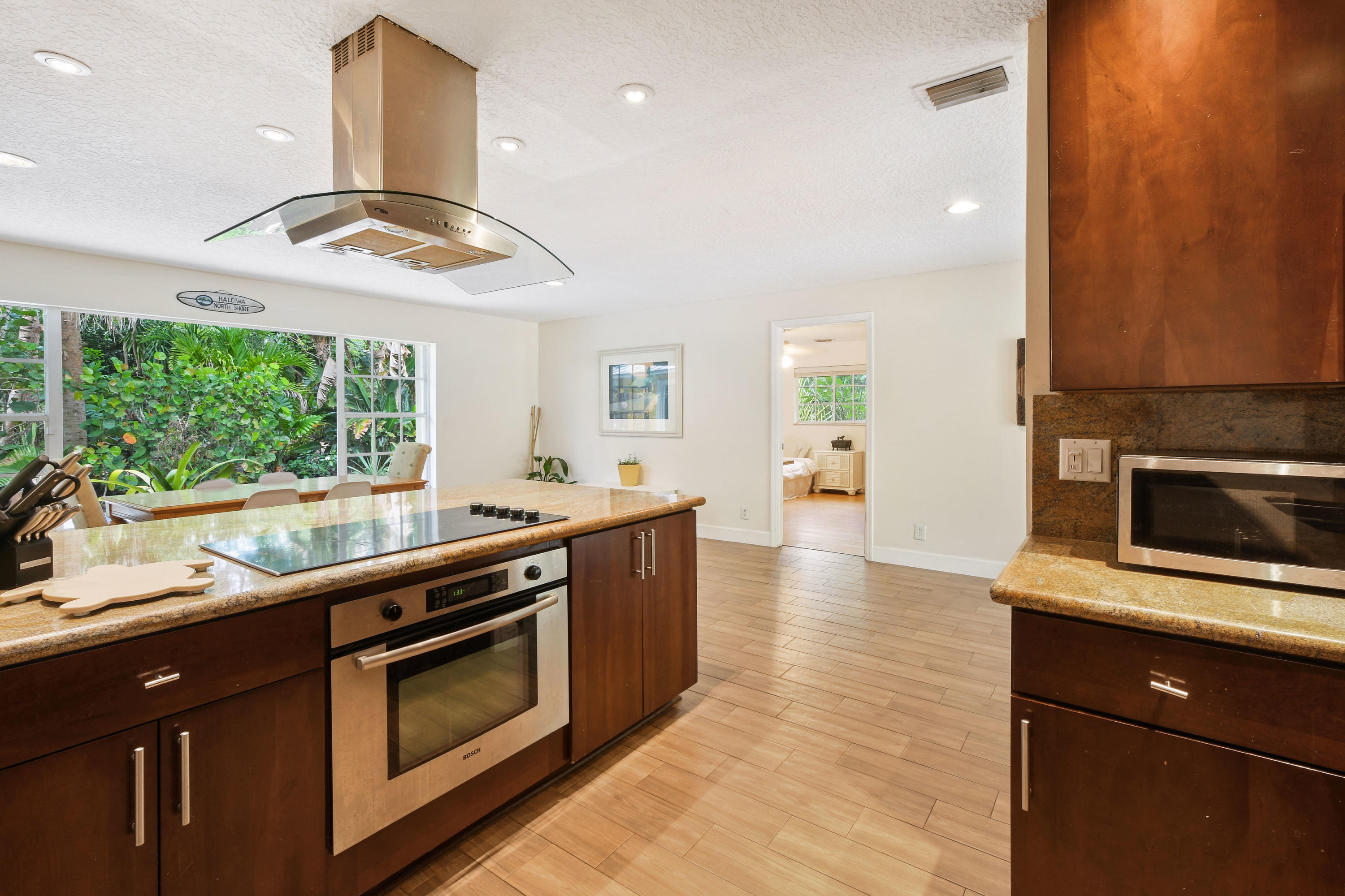19943 Pinetree Drive Jupiter, FL 33469 - Photo 12 of 42 a kitchen with stainless steel appliances granite countertop a stove a sink and a microwave