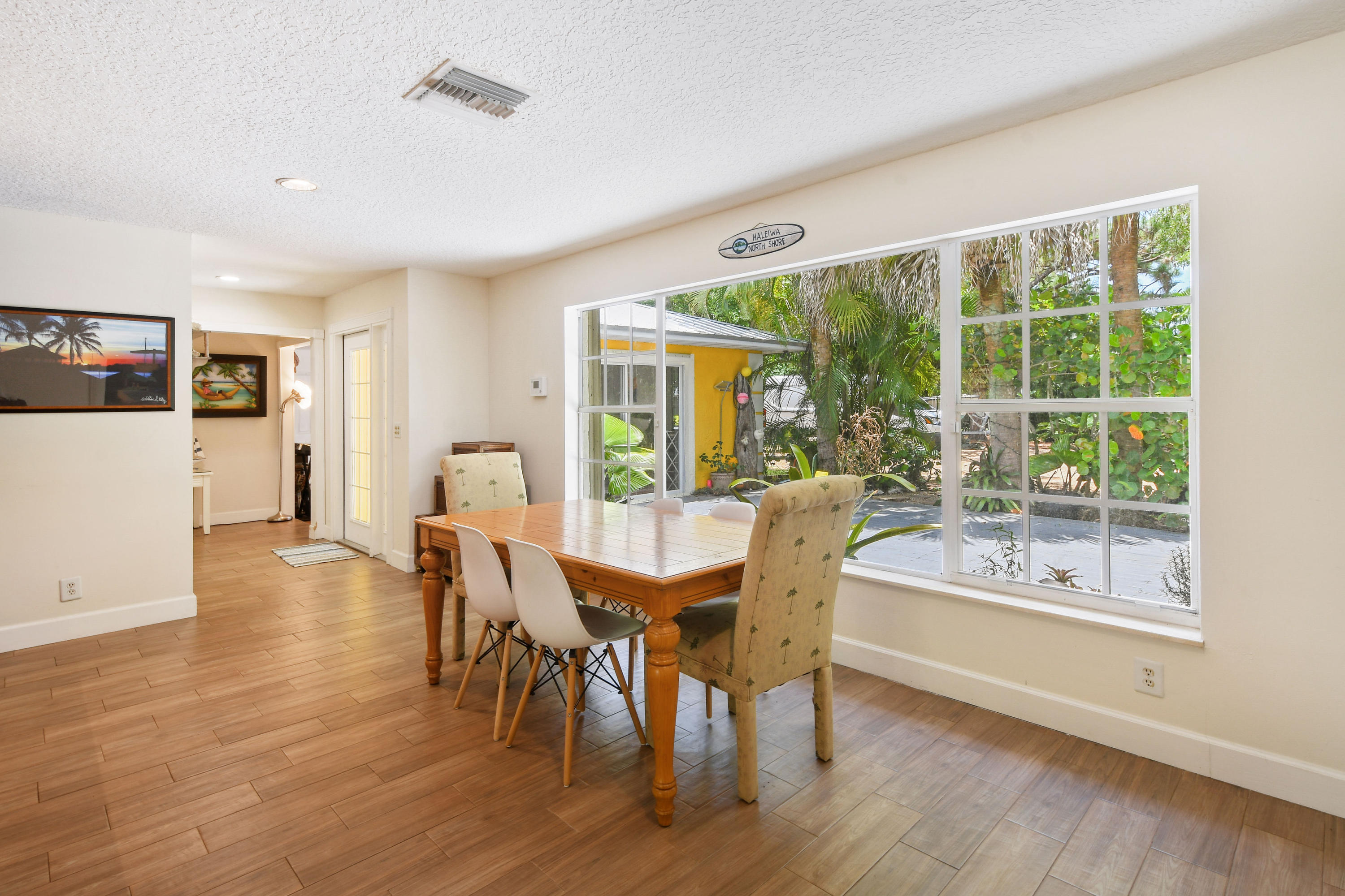 19943 Pinetree Drive Jupiter, FL 33469 - Photo 14 of 42 a view of a dining room with furniture window and wooden floor