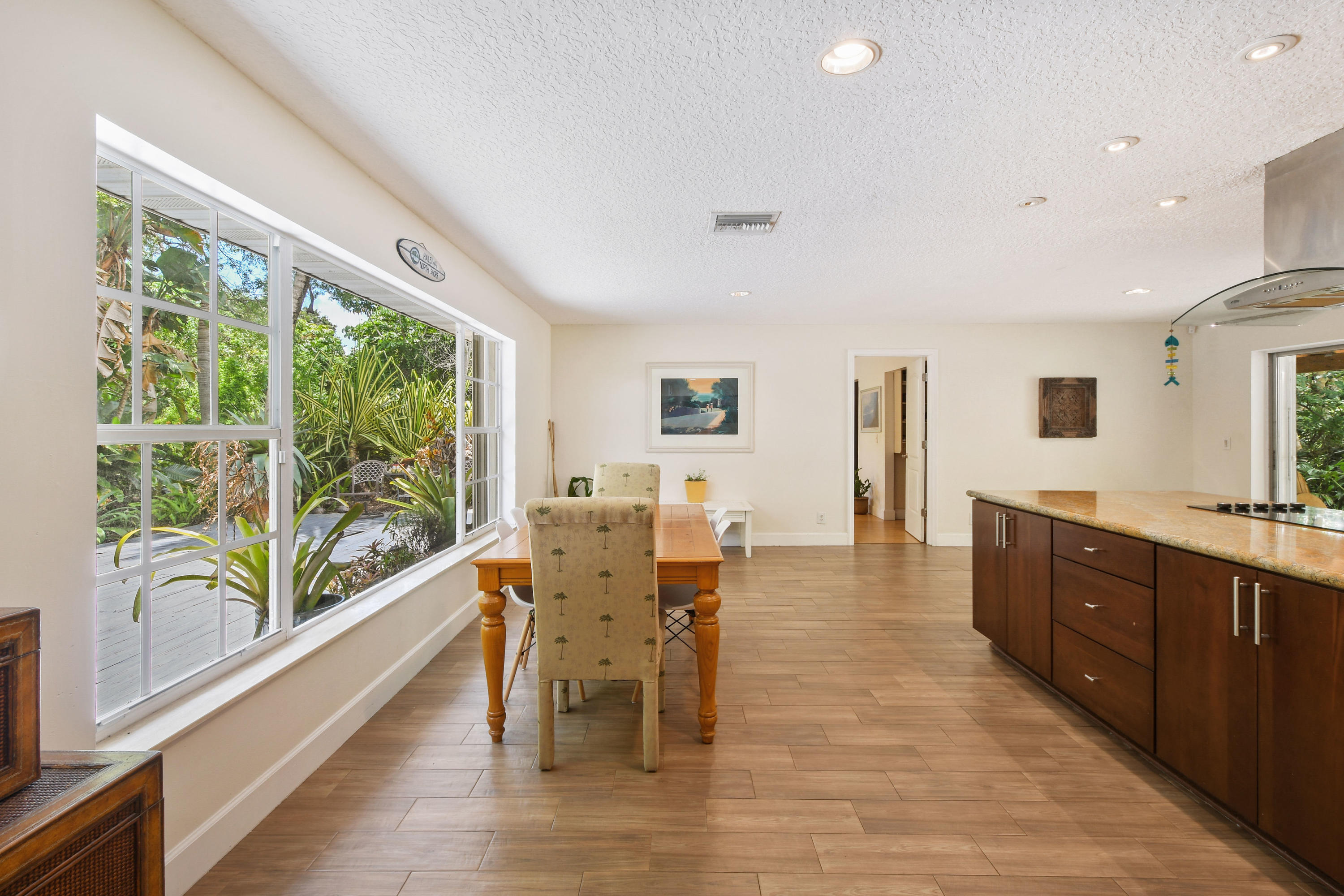 19943 Pinetree Drive Jupiter, FL 33469 - Photo 15 of 42 a view of a dining room with furniture window and wooden floor