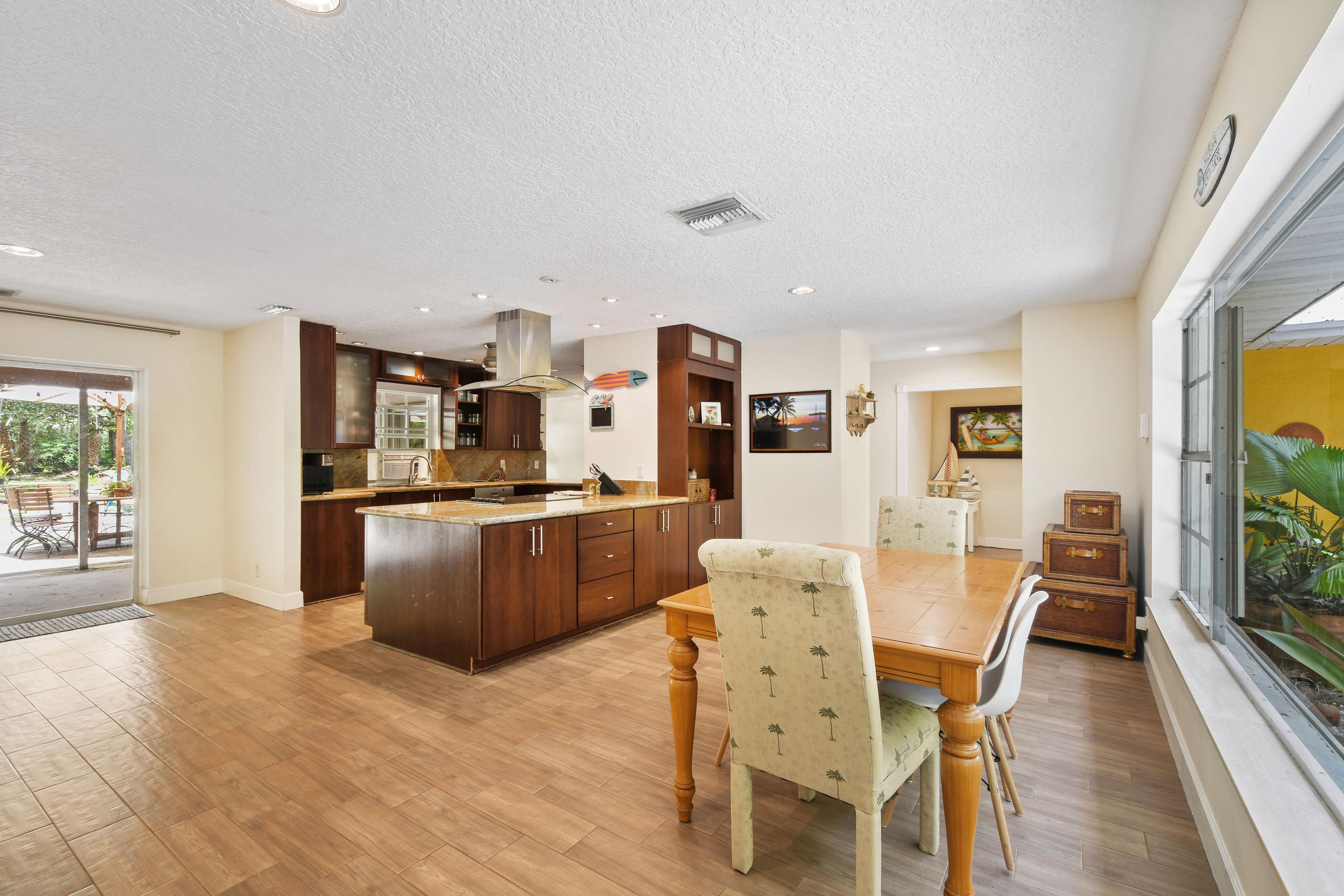 19943 Pinetree Drive Jupiter, FL 33469 - Photo 16 of 42 a living room with stainless steel appliances kitchen island granite countertop furniture and a kitchen view