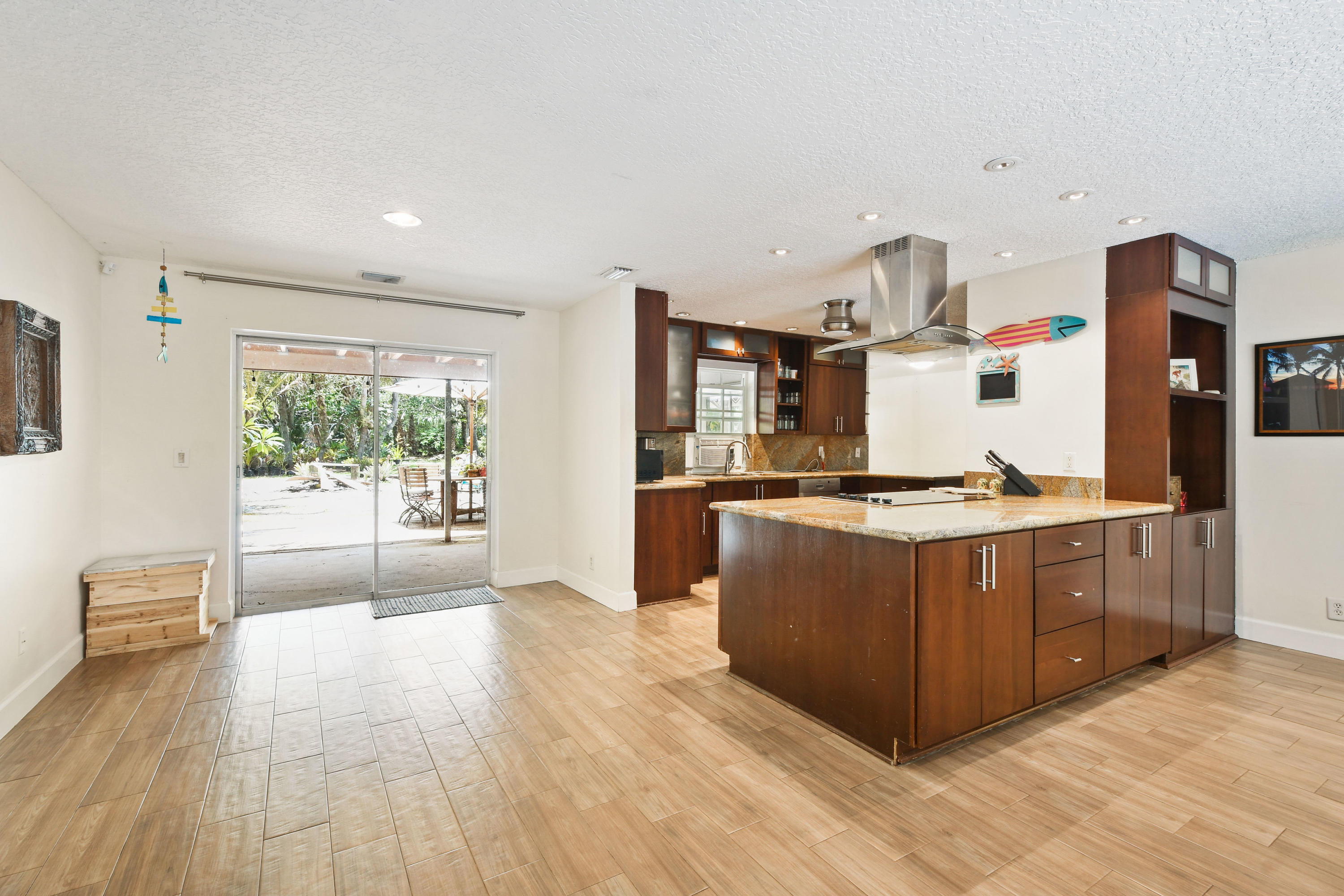19943 Pinetree Drive Jupiter, FL 33469 - Photo 17 of 42 a kitchen with stainless steel appliances granite countertop a stove a sink dishwasher and a refrigerator with wooden floor