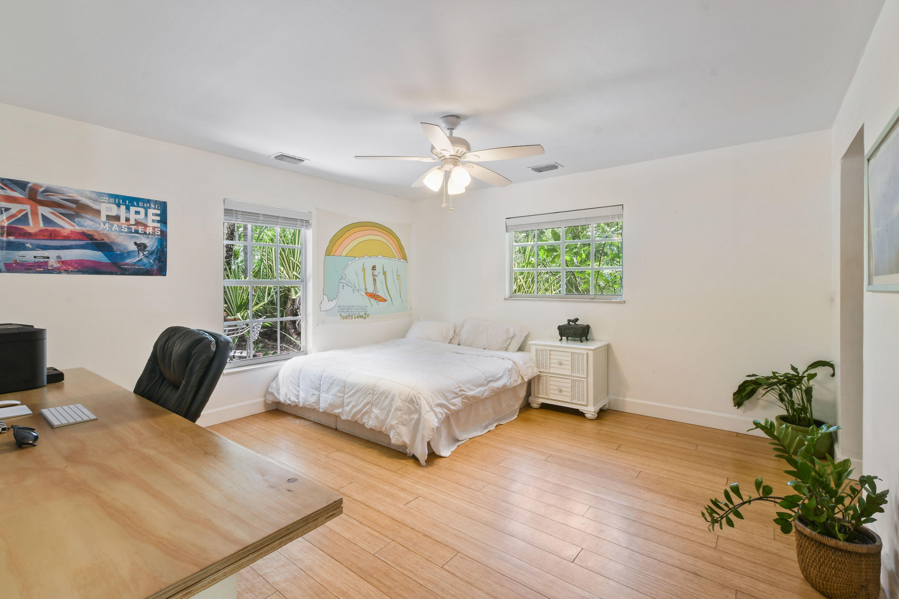 19943 Pinetree Drive Jupiter, FL 33469 - Photo 18 of 42 a bedroom with a bed lamps and table