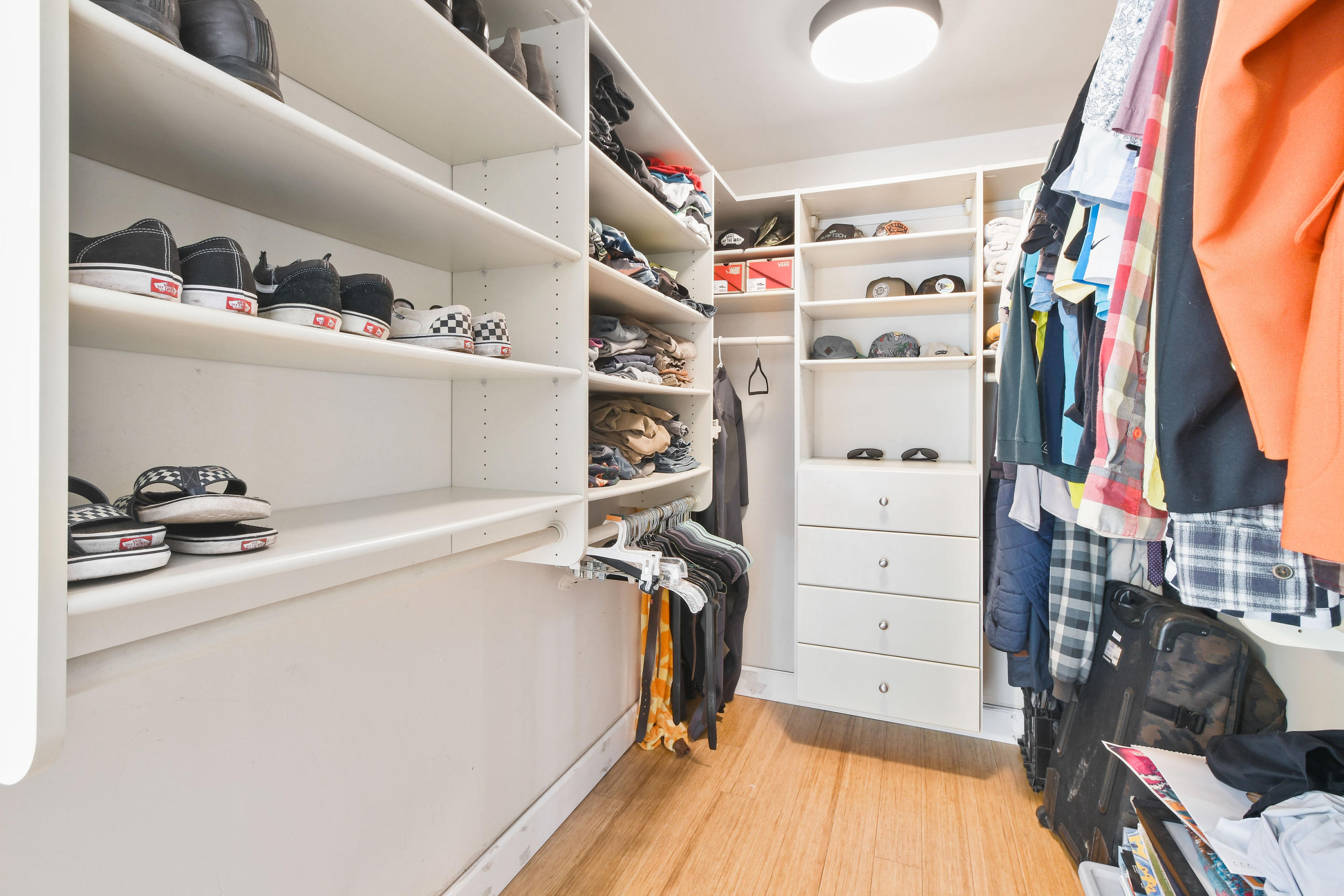 19943 Pinetree Drive Jupiter, FL 33469 - Photo 21 of 42 a view of walk in closet with clothes and shoes