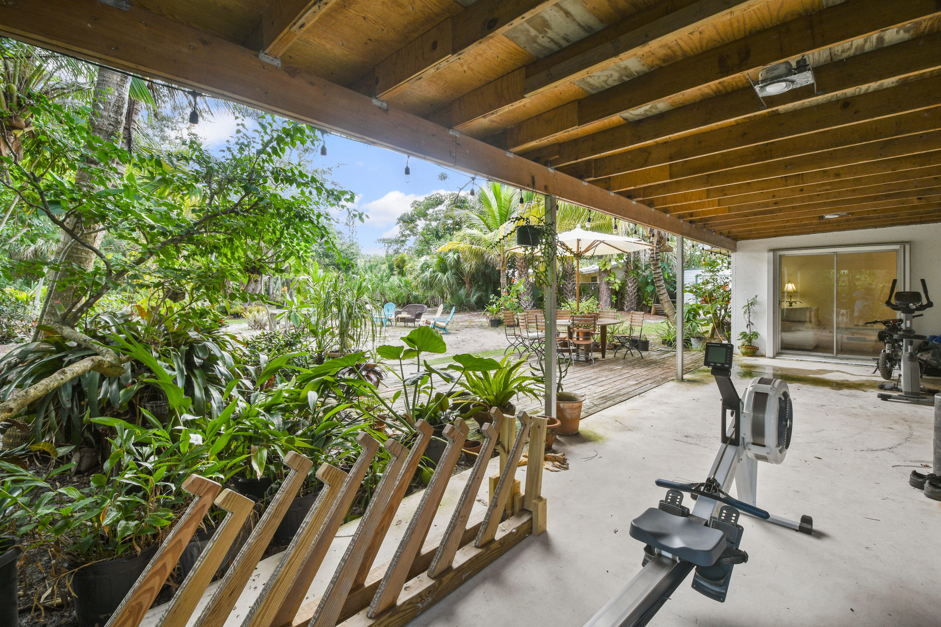 19943 Pinetree Drive Jupiter, FL 33469 - Photo 27 of 42 a view of a porch with chairs and potted plants