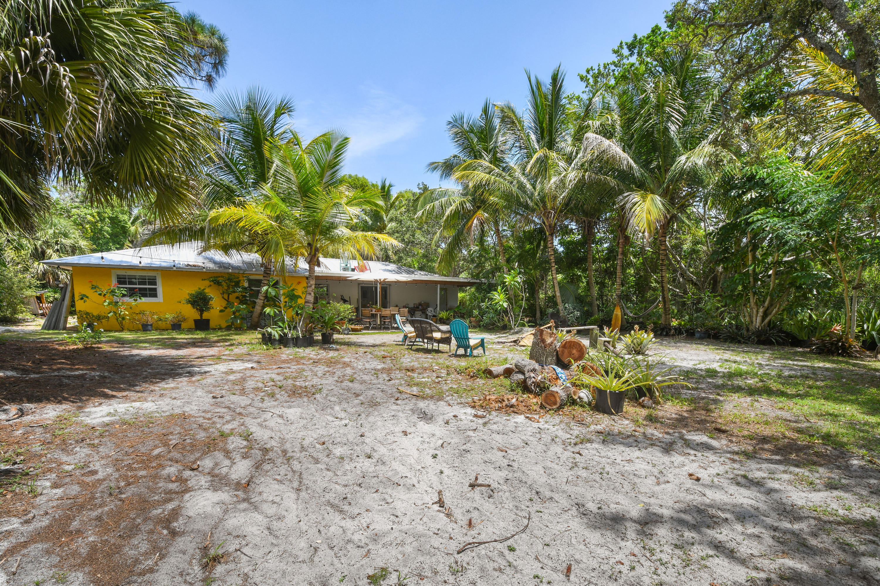 19943 Pinetree Drive Jupiter, FL 33469 - Photo 30 of 42 a view of a yard with table and chairs under an umbrella