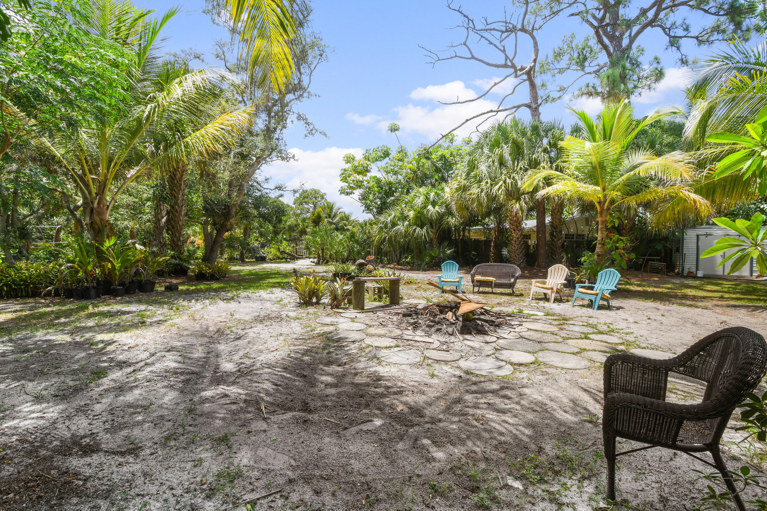 19943 Pinetree Drive Jupiter, FL 33469 - Photo 33 of 42 a view of a lake with chairs and trees