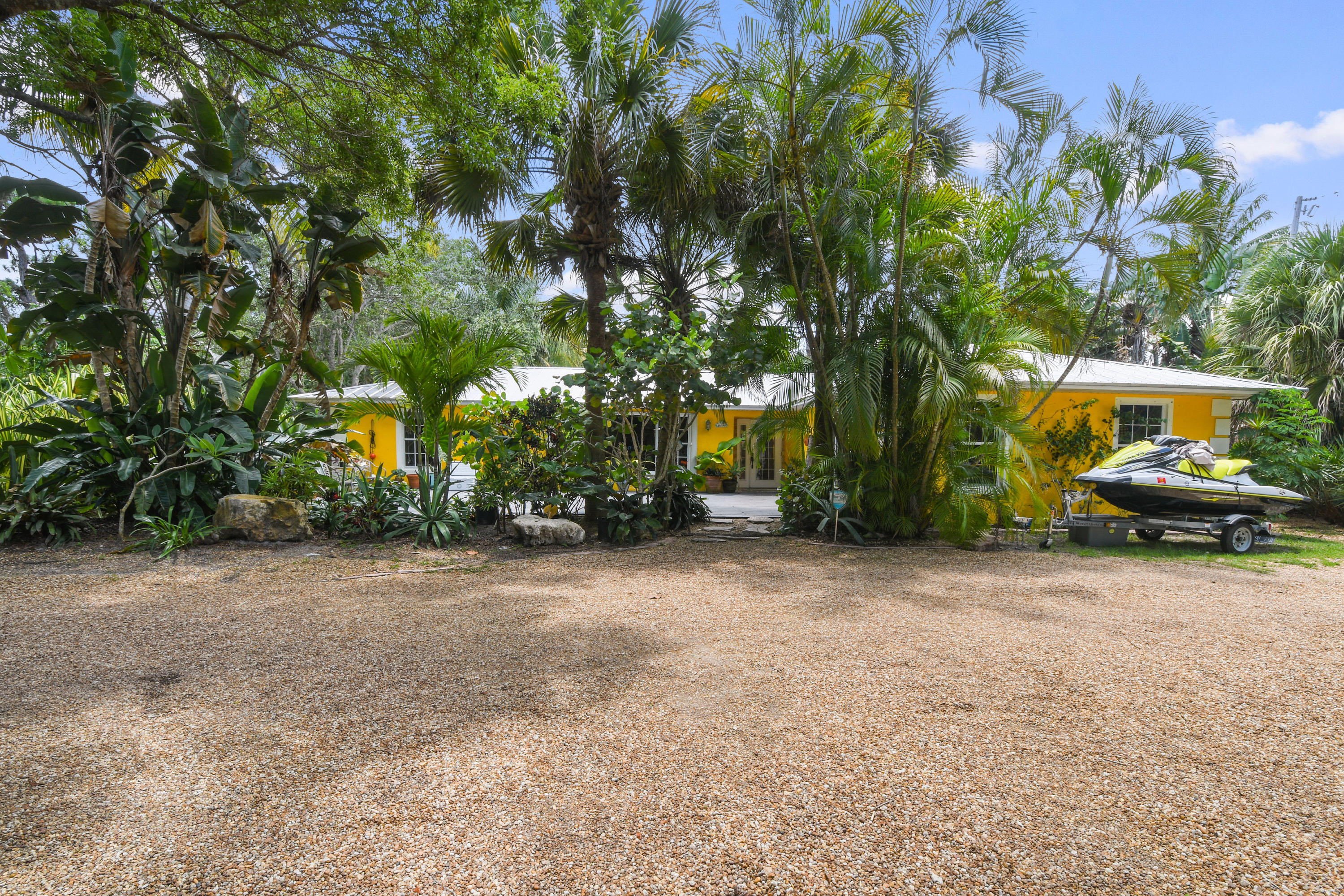 19943 Pinetree Drive Jupiter, FL 33469 - Photo 4 of 42 a view of a car park in front of a house