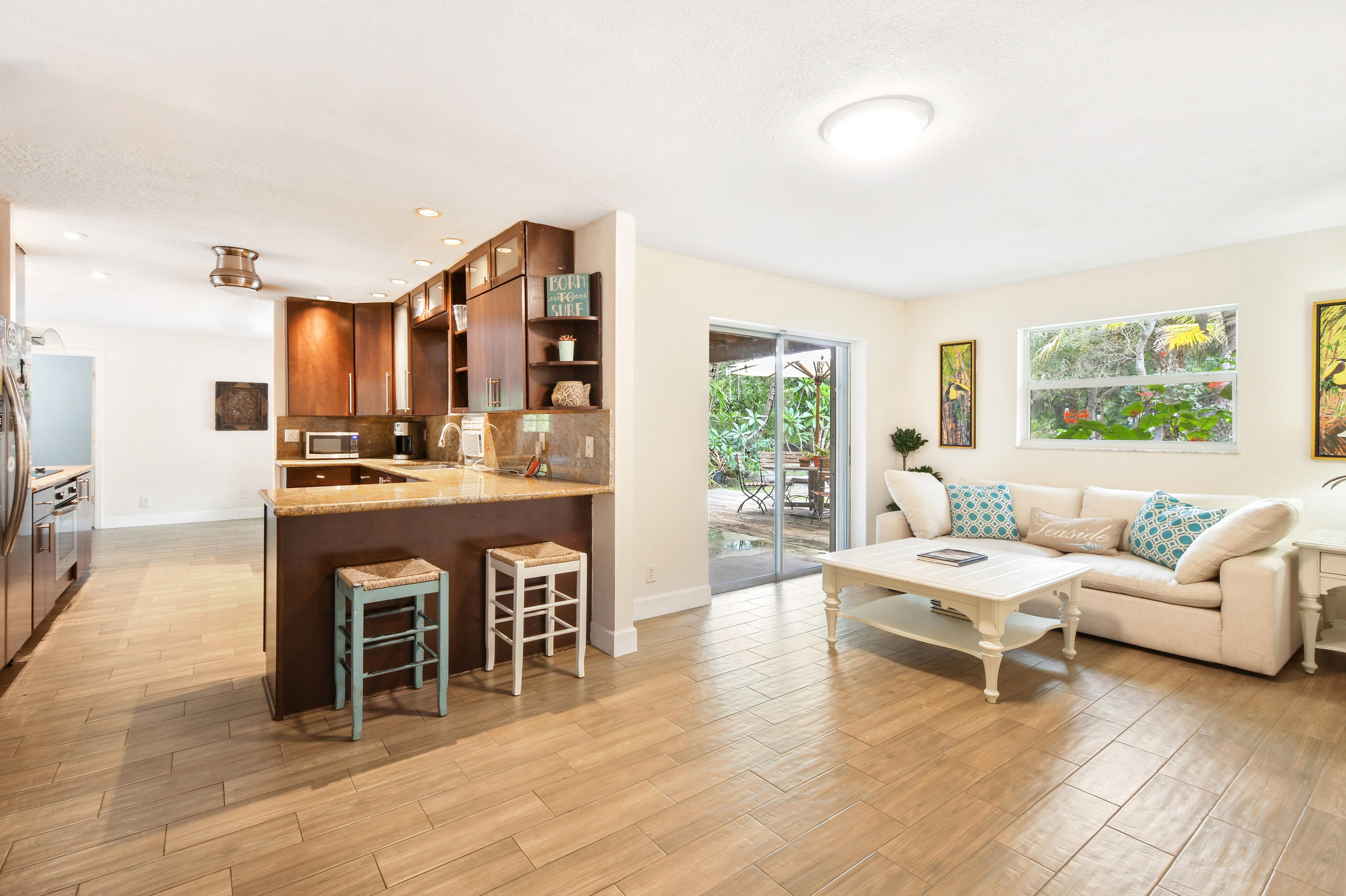 19943 Pinetree Drive Jupiter, FL 33469 - Photo 42 of 42 a living room with furniture a fireplace and a large window