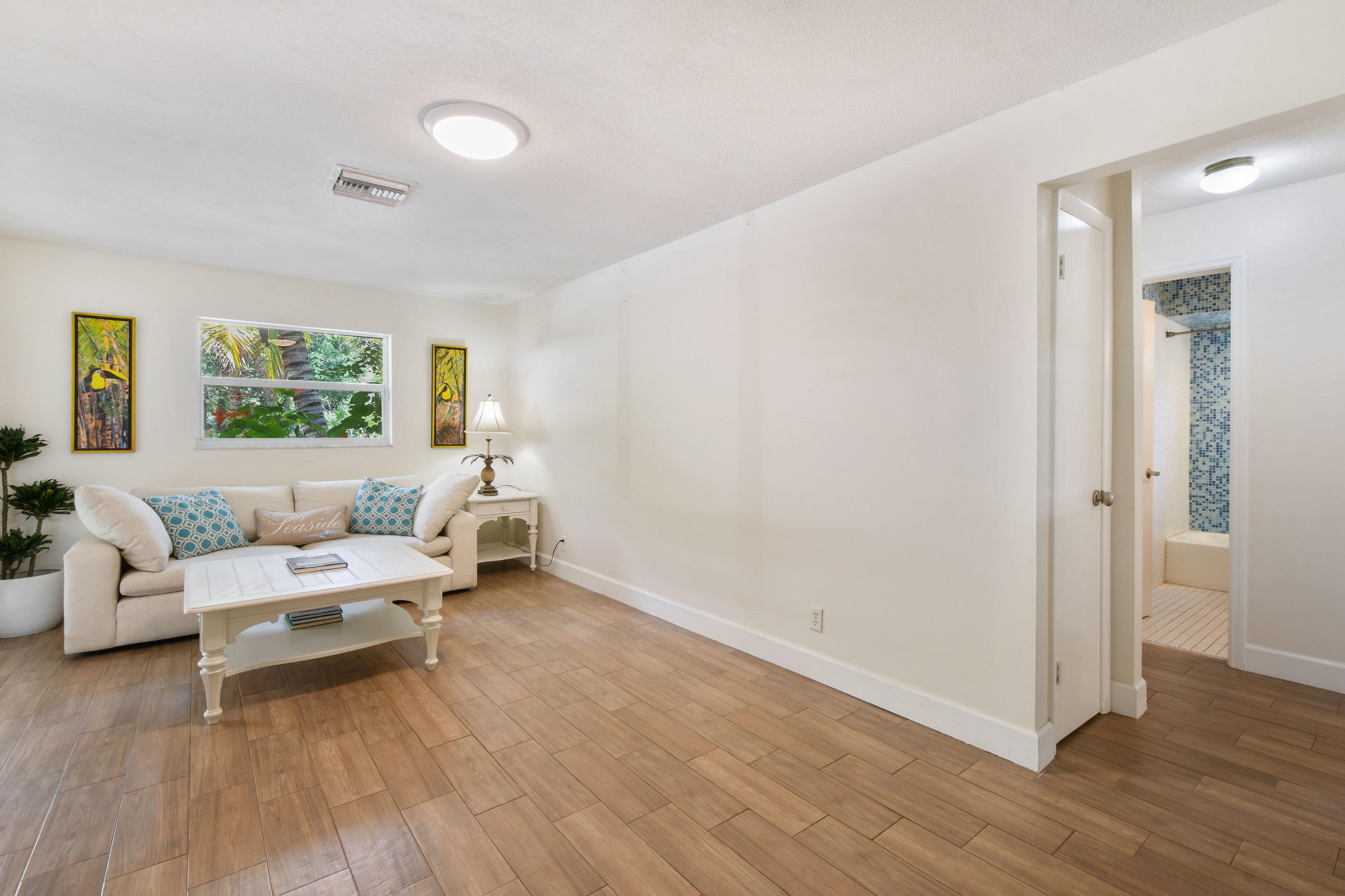 19943 Pinetree Drive Jupiter, FL 33469 - Photo 6 of 42 a living room with furniture and a wooden floor