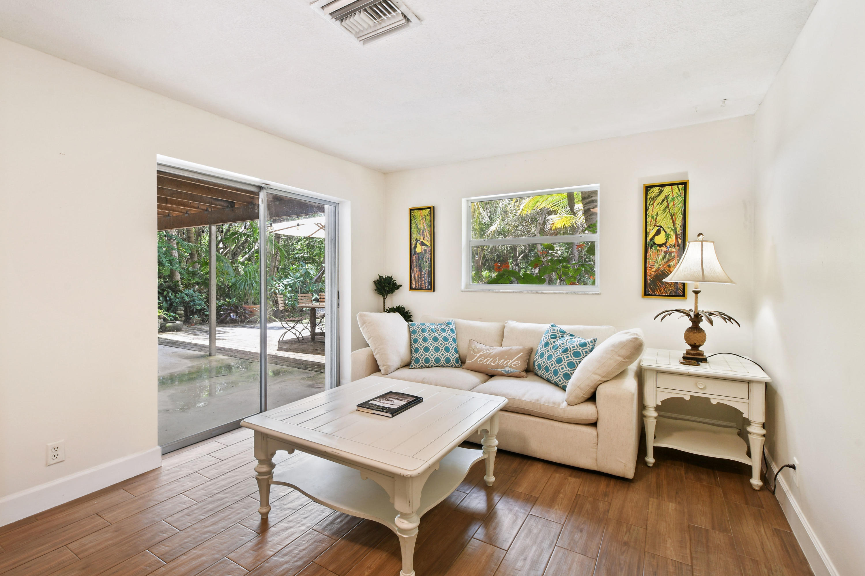 19943 Pinetree Drive Jupiter, FL 33469 - Photo 7 of 42 a living room with furniture and a large window