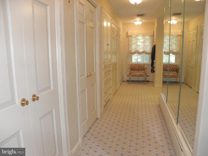 7004 Nevis Road Bethesda, MD 20817 - Photo 13 of 24 a bathroom with a glass shower door