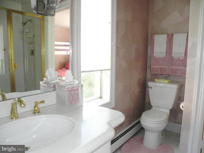 7004 Nevis Road Bethesda, MD 20817 - Photo 18 of 24 a bathroom with a granite countertop sink toilet and shower
