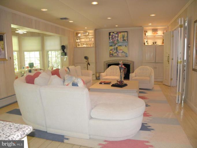 7004 Nevis Road Bethesda, MD 20817 - Photo 8 of 24 a living room with furniture a window and mirror