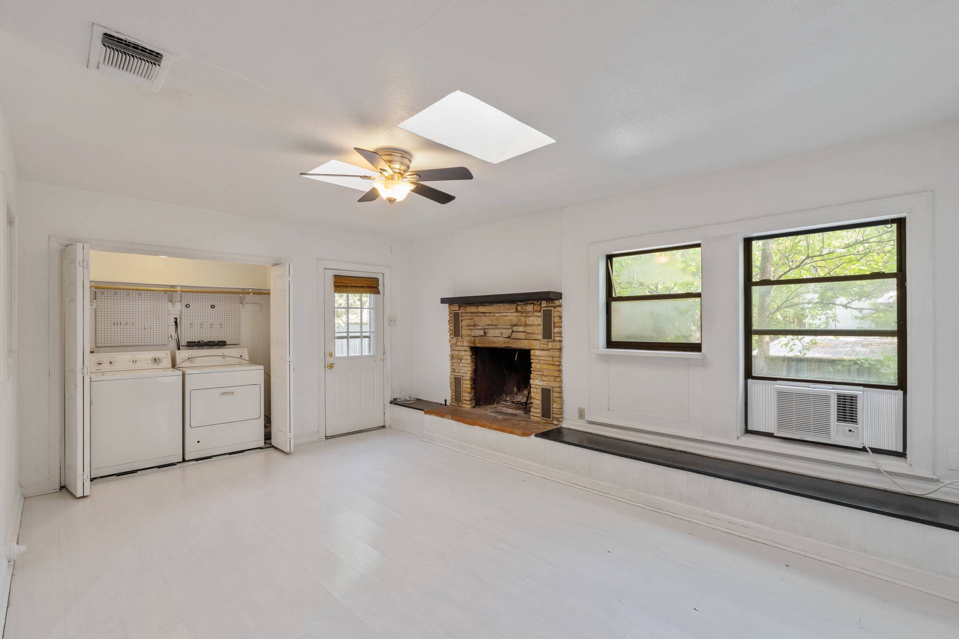 406 East Monroe Street, Unit B Austin, TX 78704 - Photo 16 of 35 a view of an empty room with a fireplace and a window