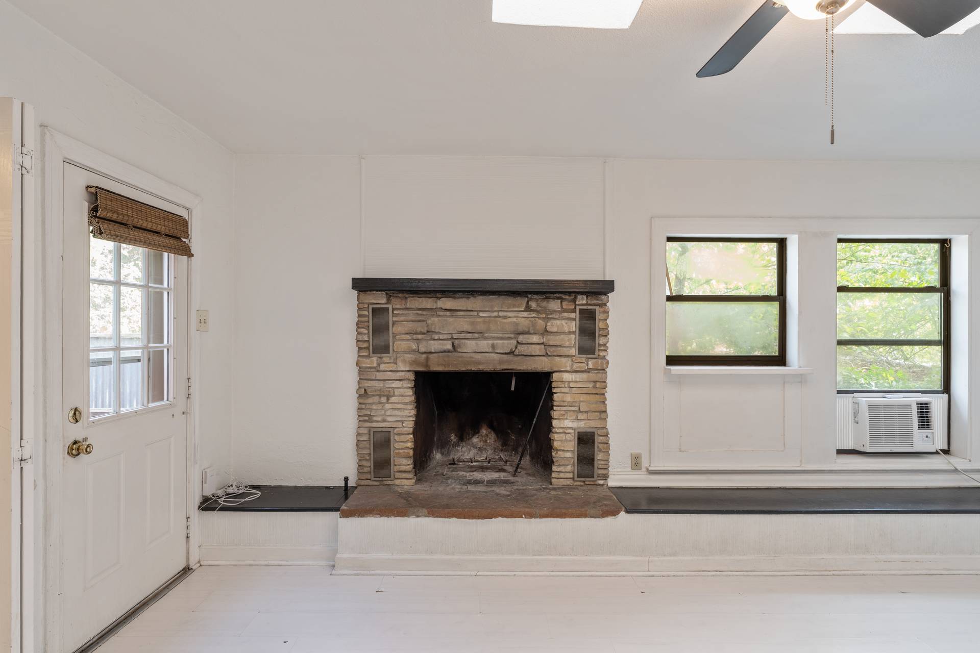 406 East Monroe Street, Unit B Austin, TX 78704 - Photo 17 of 35 a living room with a fireplace and windows