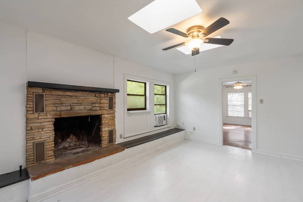 406 East Monroe Street, Unit B Austin, TX 78704 - Photo 19 of 35 a view of an empty room with chandelier fan and fire place