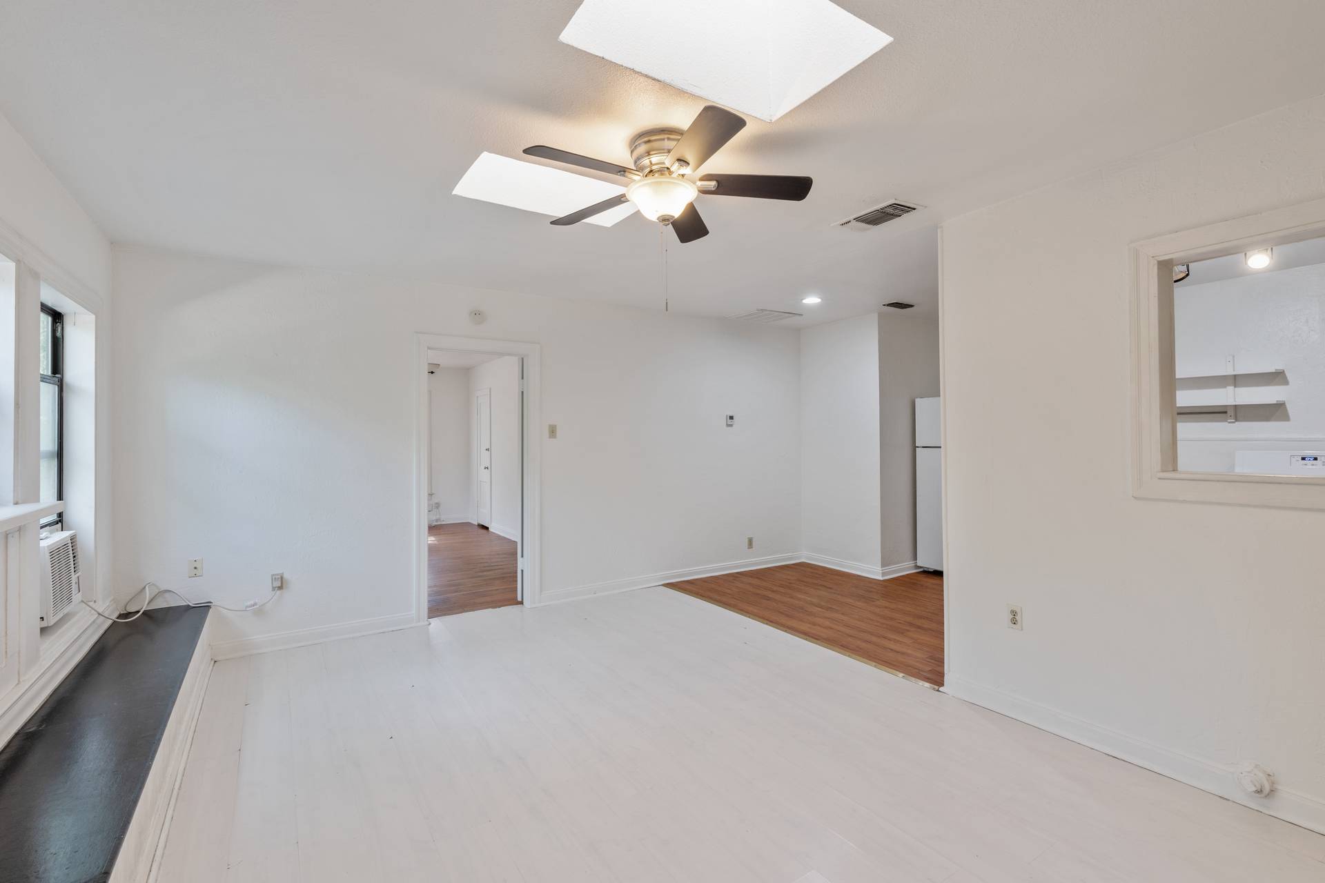 406 East Monroe Street, Unit B Austin, TX 78704 - Photo 21 of 35 Unfurnished room featuring a skylight, light wood-type flooring, and ceiling fan