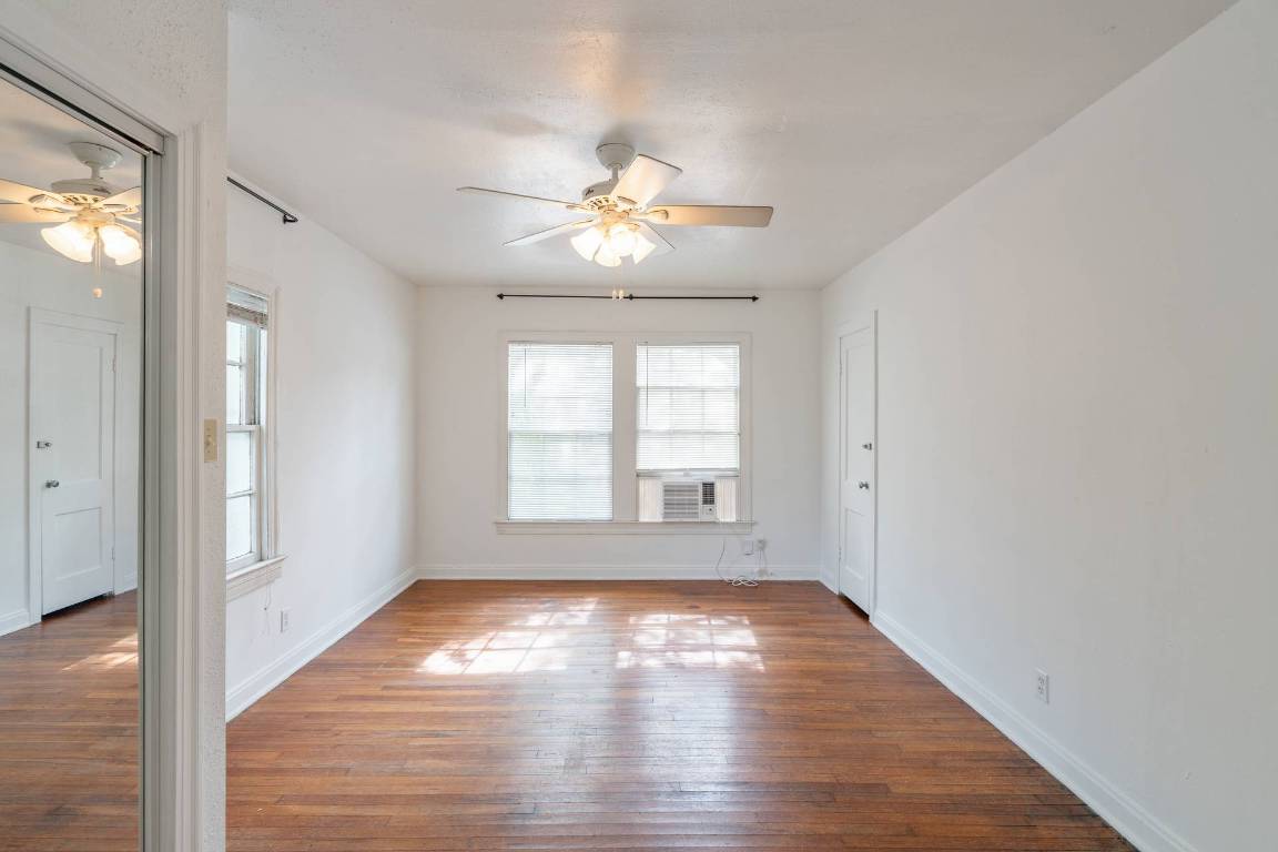 406 East Monroe Street, Unit B Austin, TX 78704 - Photo 22 of 35 a view of empty room with wooden floor and fan