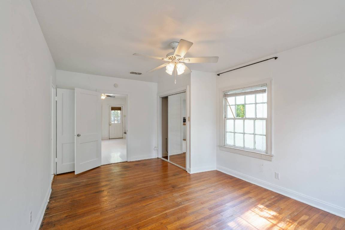 406 East Monroe Street, Unit B Austin, TX 78704 - Photo 24 of 35 Unfurnished room featuring ceiling fan and hardwood / wood-style flooring