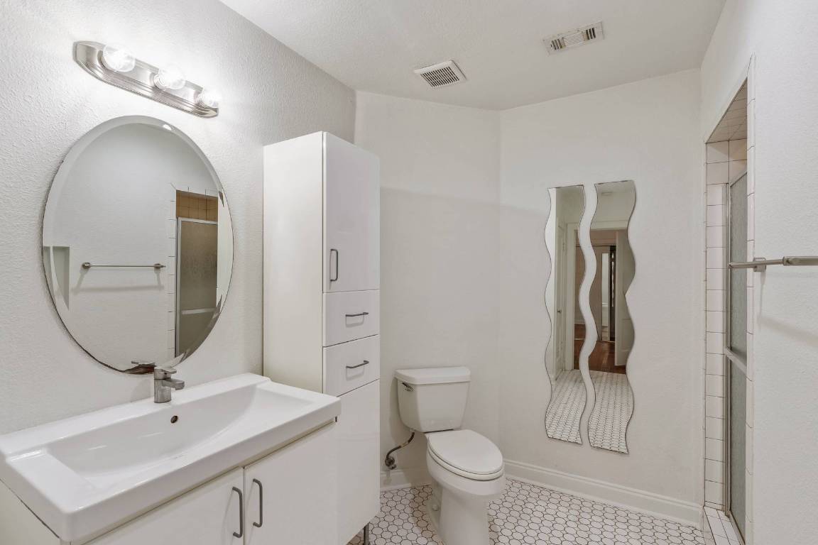 406 East Monroe Street, Unit B Austin, TX 78704 - Photo 26 of 35 a bathroom with a toilet sink and mirror