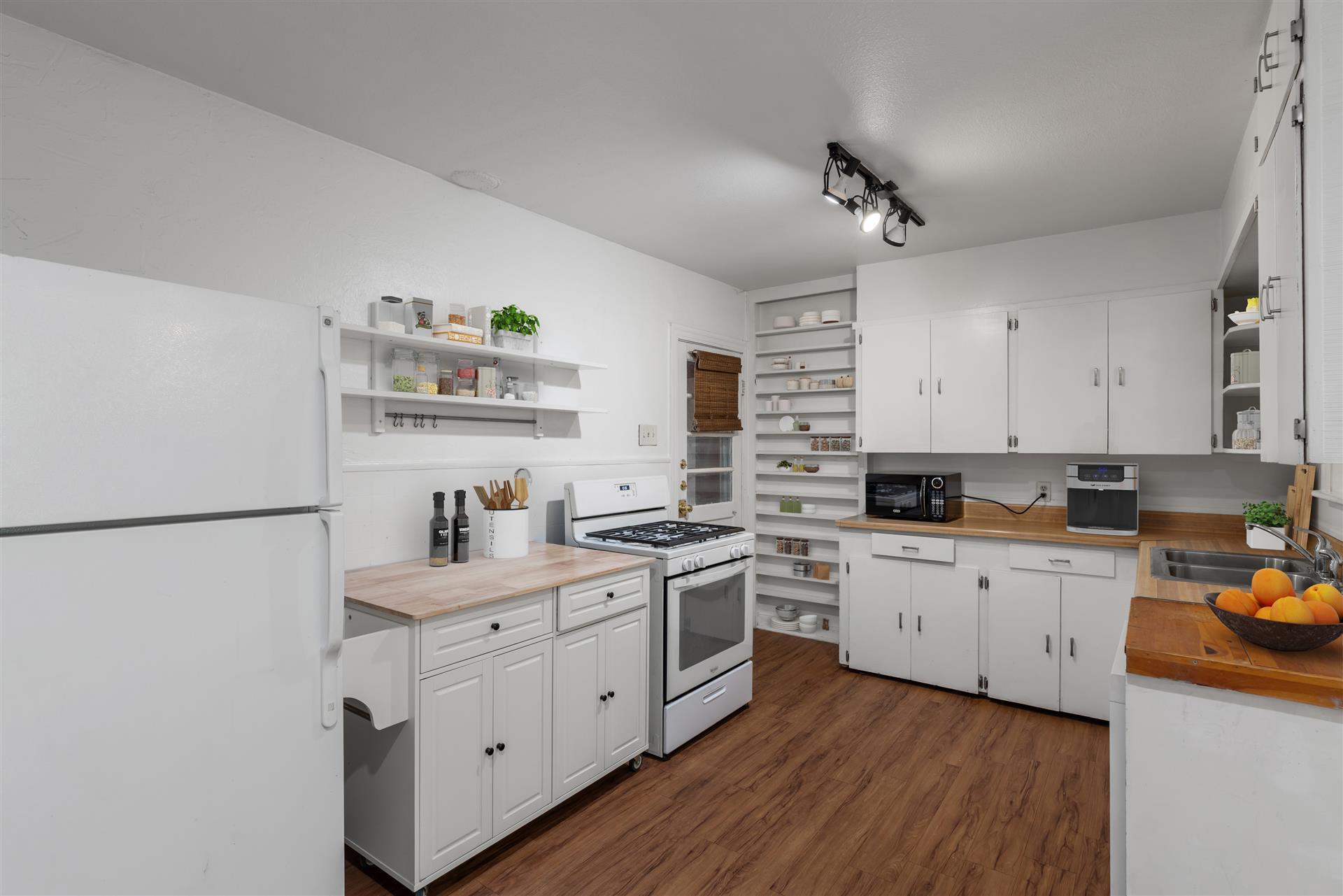 406 East Monroe Street, Unit B Austin, TX 78704 - Photo 3 of 35 a kitchen with white cabinets and white appliances