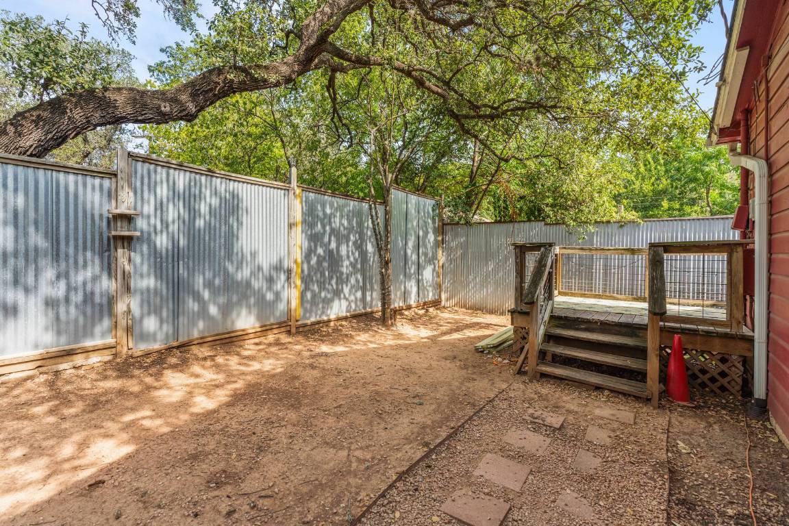406 East Monroe Street, Unit B Austin, TX 78704 - Photo 31 of 35 a view of backyard with wooden fence and a large tree