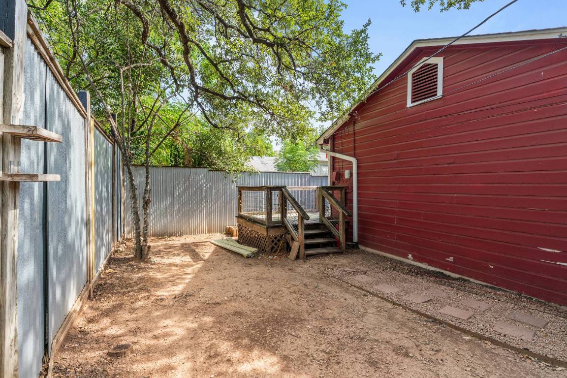 406 East Monroe Street, Unit B Austin, TX 78704 - Photo 32 of 35 Fenced backyard featuring a wooden deck