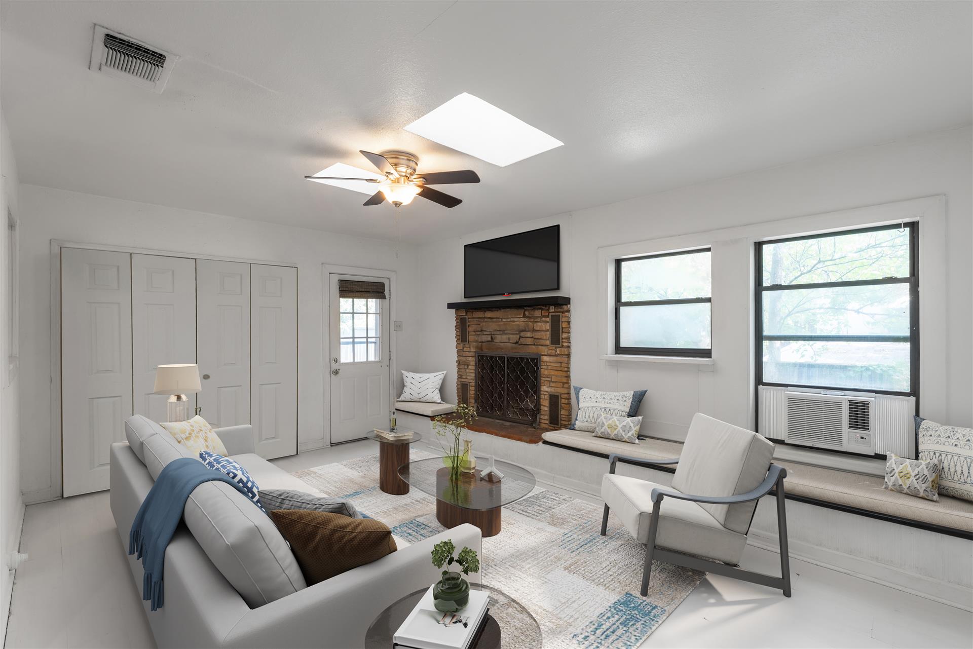 406 East Monroe Street, Unit B Austin, TX 78704 - Photo 5 of 35 a living room with furniture a fireplace and a large window