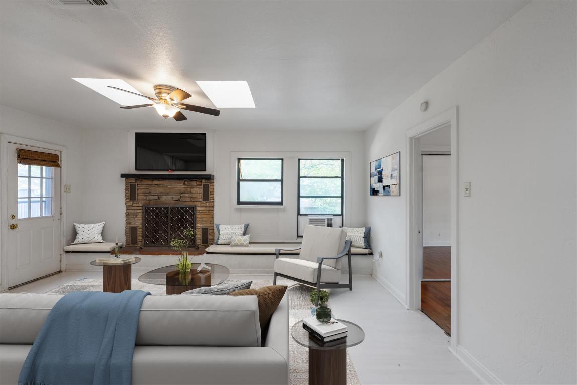 406 East Monroe Street, Unit B Austin, TX 78704 - Photo 6 of 35 a living room with furniture a fireplace and a flat screen tv