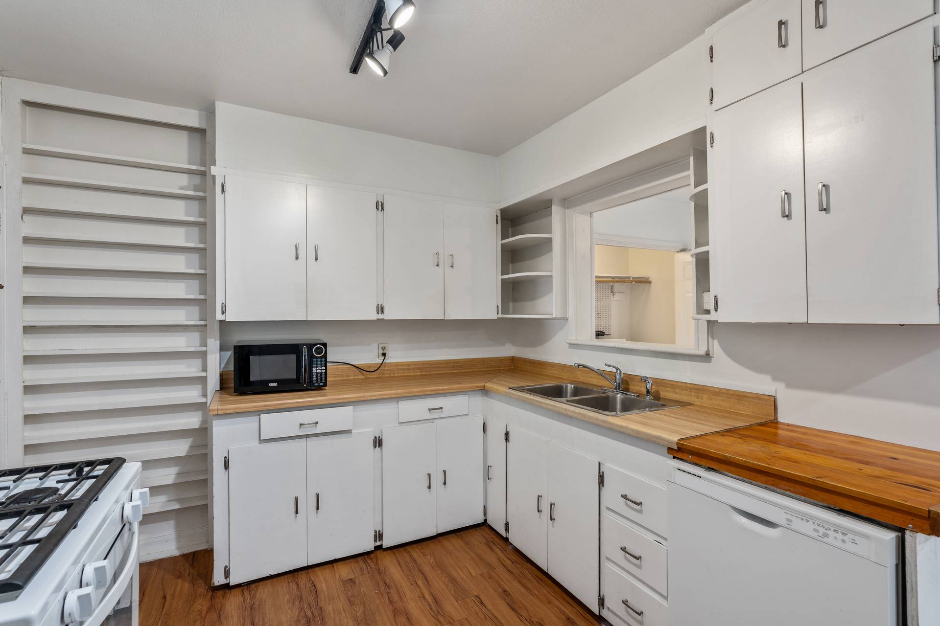 406 East Monroe Street, Unit B Austin, TX 78704 - Photo 10 of 35 a kitchen with granite countertop white cabinets and white appliances