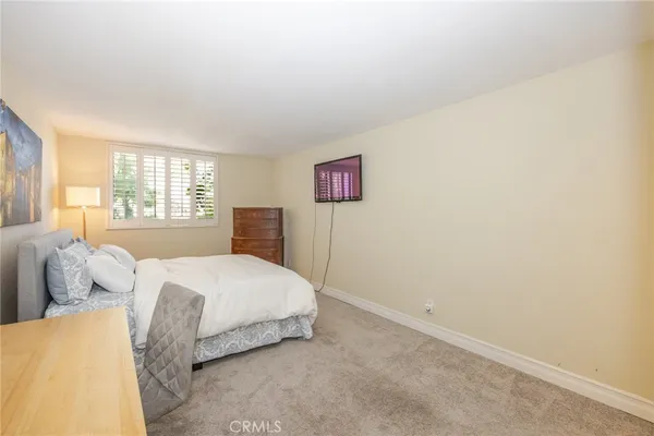 a spacious bedroom with a bed and a window