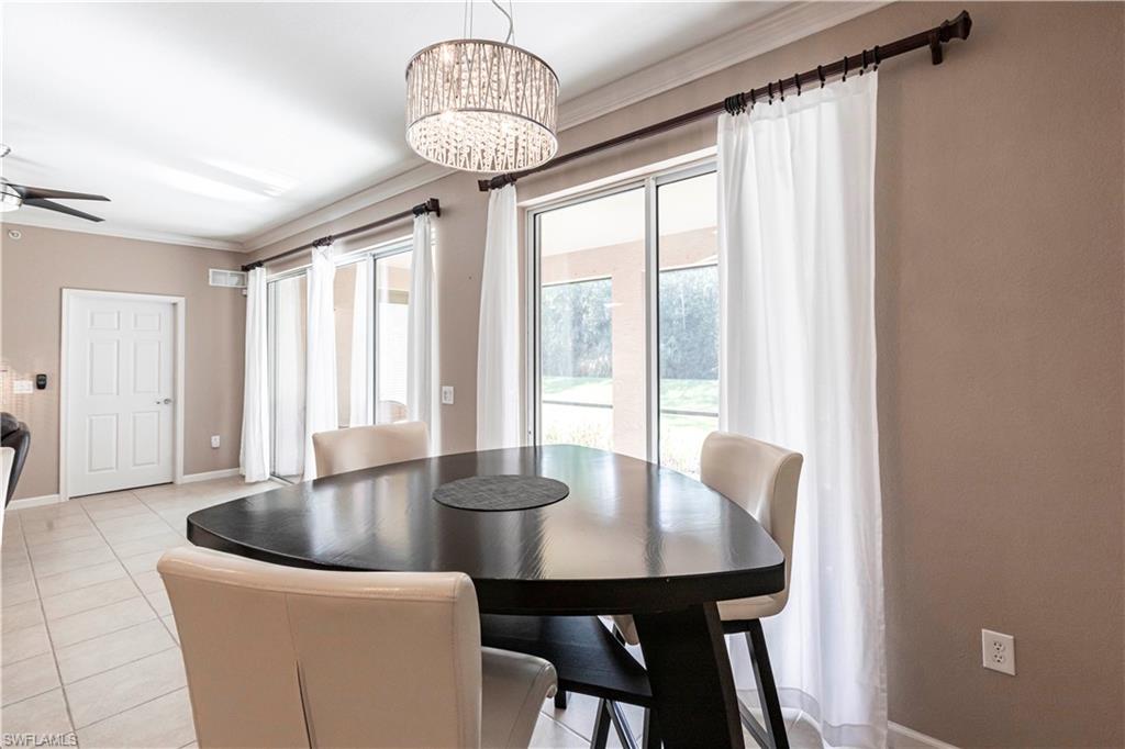 9508 Ironstone Terrace, Unit 2102 Naples, FL 34120 - Photo 15 of 50 a view of a dining room with furniture wooden floor and chandelier