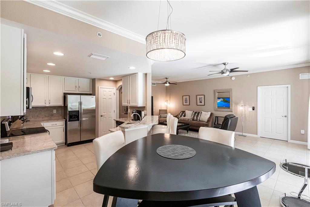9508 Ironstone Terrace, Unit 2102 Naples, FL 34120 - Photo 16 of 50 a large kitchen with a table and chairs