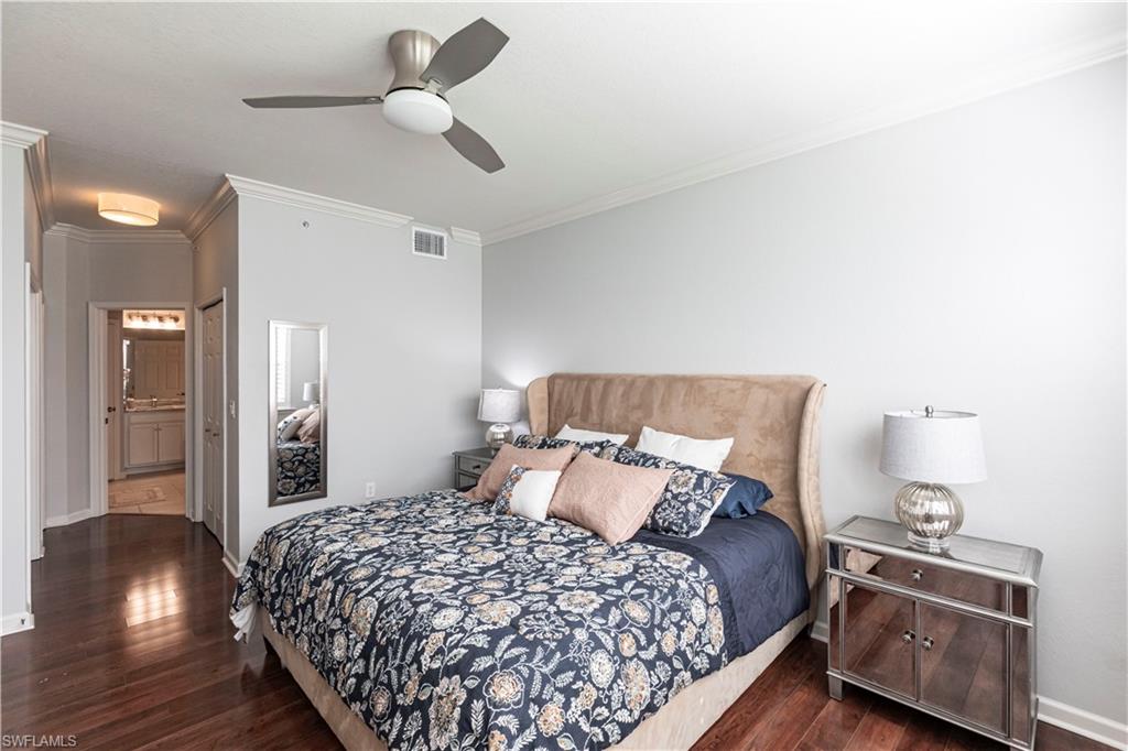 9508 Ironstone Terrace, Unit 2102 Naples, FL 34120 - Photo 19 of 50 a bedroom with a bed and wooden floor