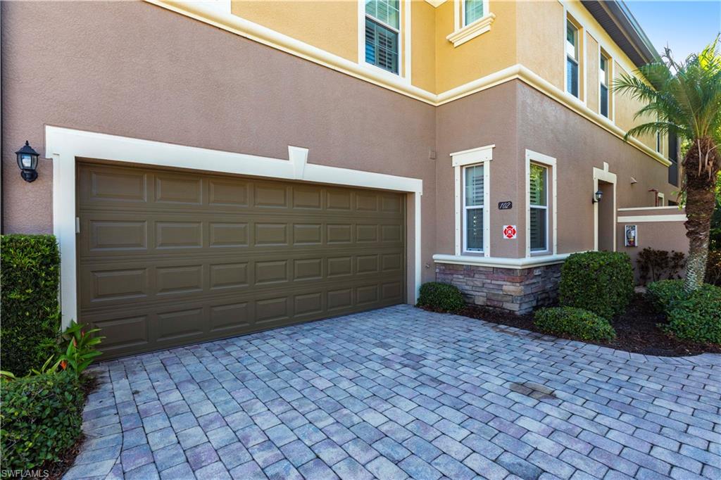 9508 Ironstone Terrace, Unit 2102 Naples, FL 34120 - Photo 2 of 50 a view of a house with a yard