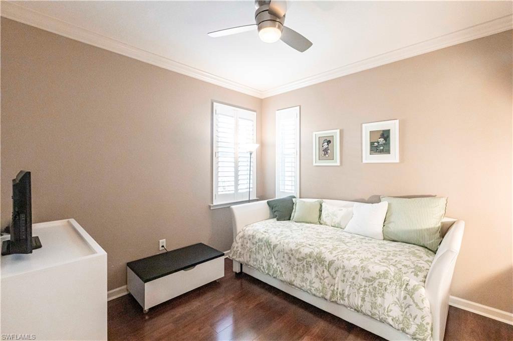 9508 Ironstone Terrace, Unit 2102 Naples, FL 34120 - Photo 25 of 50 a bedroom with a bed and a desk