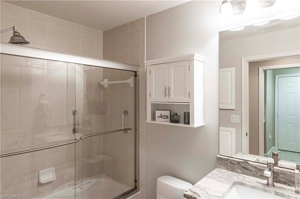 9508 Ironstone Terrace, Unit 2102 Naples, FL 34120 - Photo 29 of 50 a bathroom with a shower and a toilet