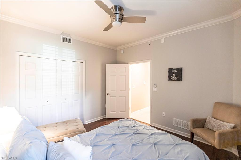 9508 Ironstone Terrace, Unit 2102 Naples, FL 34120 - Photo 31 of 50 a bedroom with a bed and a chair
