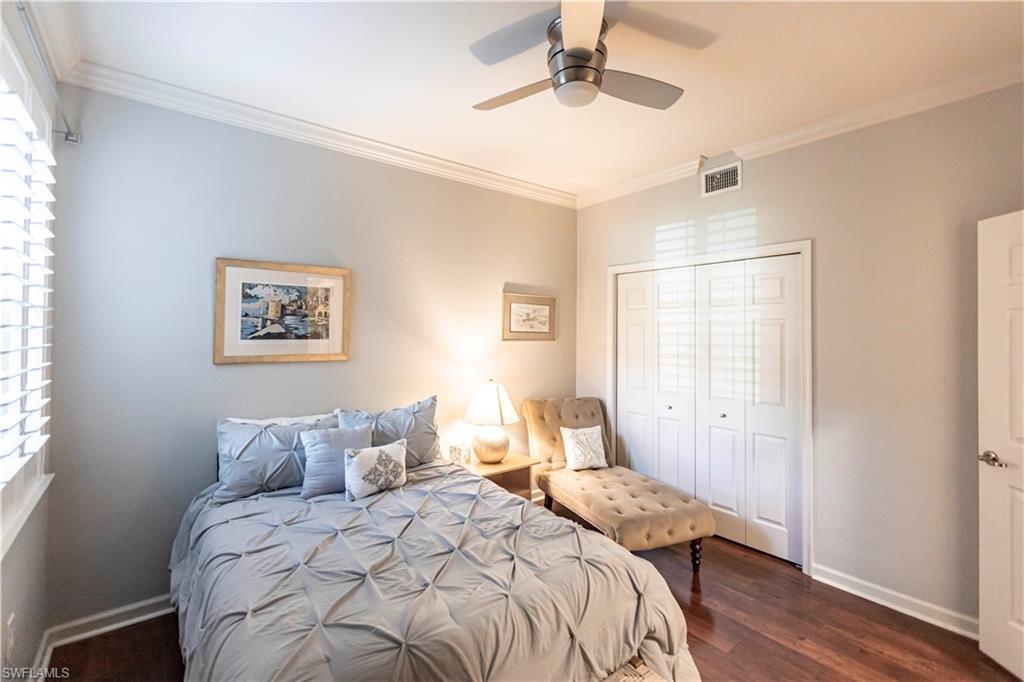 9508 Ironstone Terrace, Unit 2102 Naples, FL 34120 - Photo 32 of 50 a bedroom with a bed and wooden floor