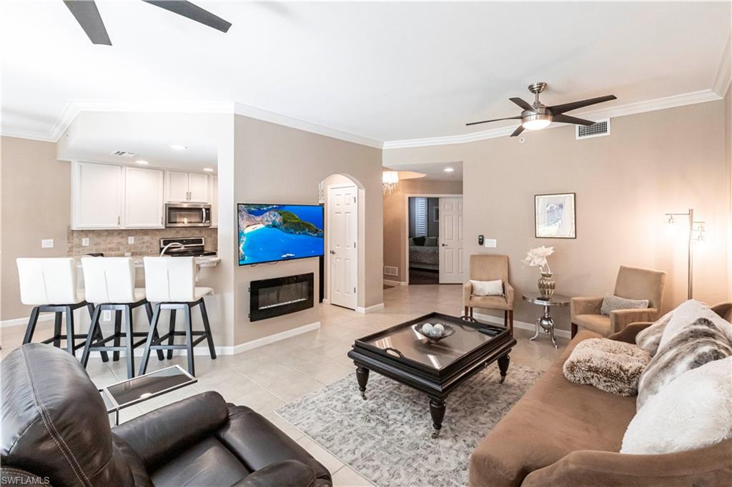 9508 Ironstone Terrace, Unit 2102 Naples, FL 34120 - Photo 6 of 50 a living room with furniture and a fireplace