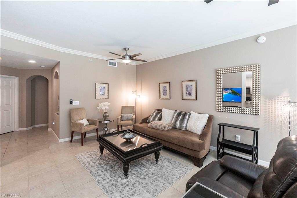 9508 Ironstone Terrace, Unit 2102 Naples, FL 34120 - Photo 7 of 50 a living room with furniture and a chandelier