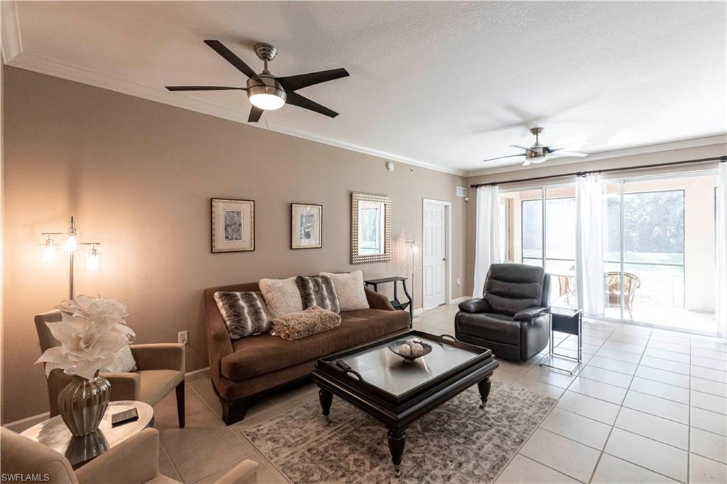 9508 Ironstone Terrace, Unit 2102 Naples, FL 34120 - Photo 8 of 50 a living room with furniture and a large window