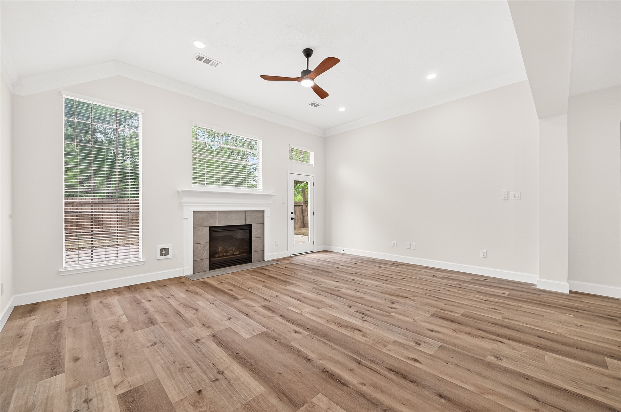6714 Cleft Stone Drive Houston, TX 77084 - Photo 11 of 49 a view of an empty room with wooden floor fireplace and a window