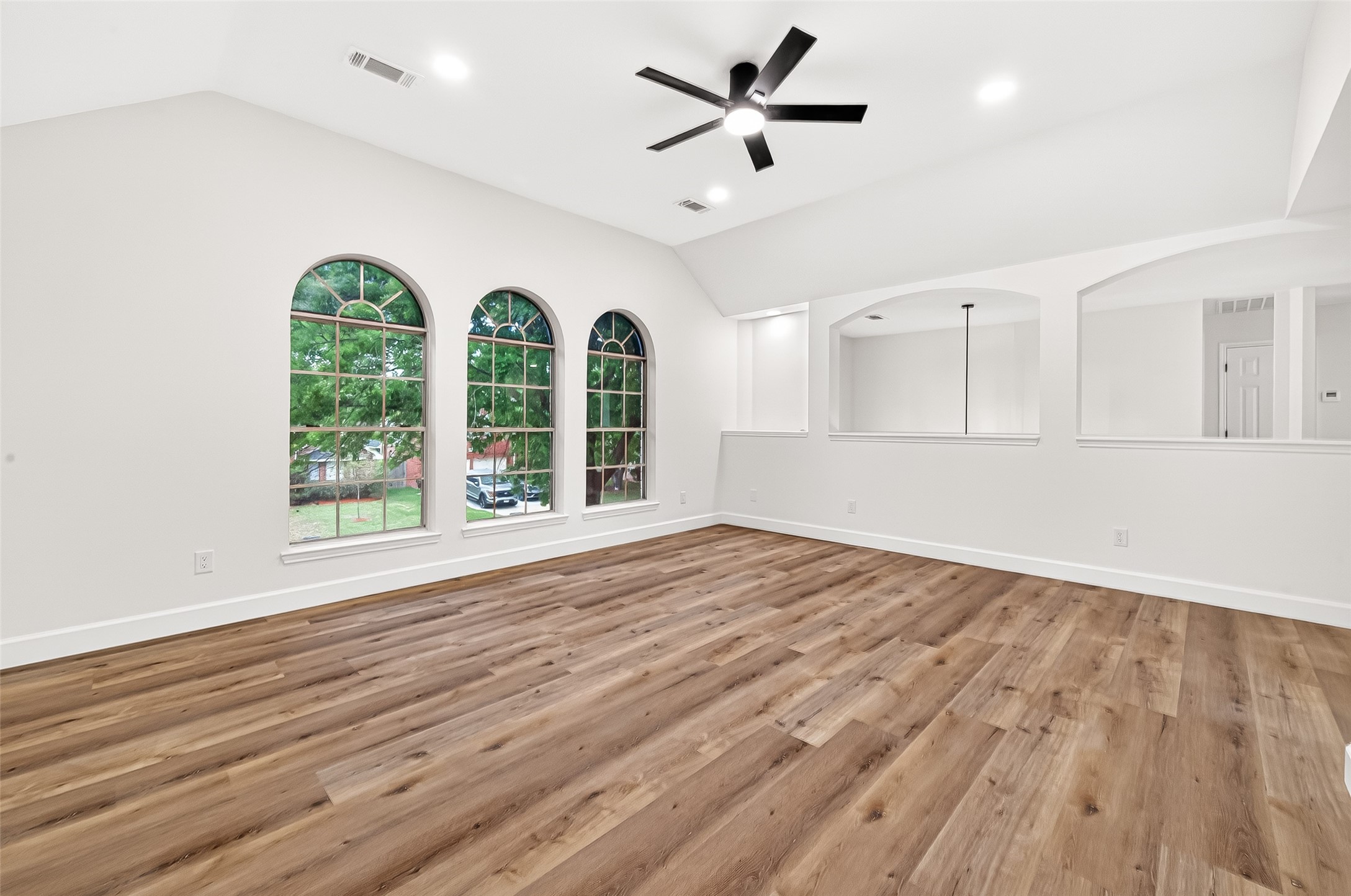 6714 Cleft Stone Drive Houston, TX 77084 - Photo 30 of 49 a view of an empty room with a window and wooden floor