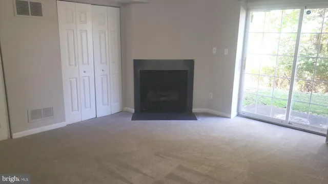 a view of empty room with floor to ceiling window